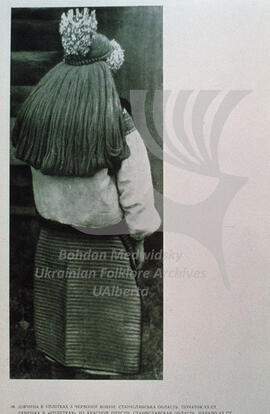 A girl is wearing uplitky made from red wool. Stanislav region. Early XXth century.