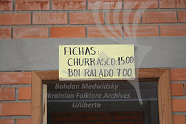 A sign with menu for festa food (churrasco) and prices
