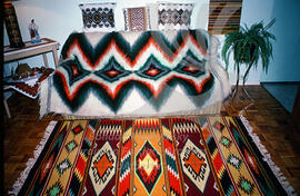 A living room decorated with embroidered pillows and woven carpets