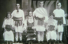 Old photo depicting men and women in national costumes.