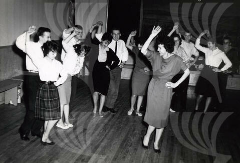 Rusalka Ukrainian Dance Ensemble – Calgary, AB, 1961.
During a weekly dance rehearsal, artistic director Nadia Korpus demonstrates a dance step for an upcoming performance.